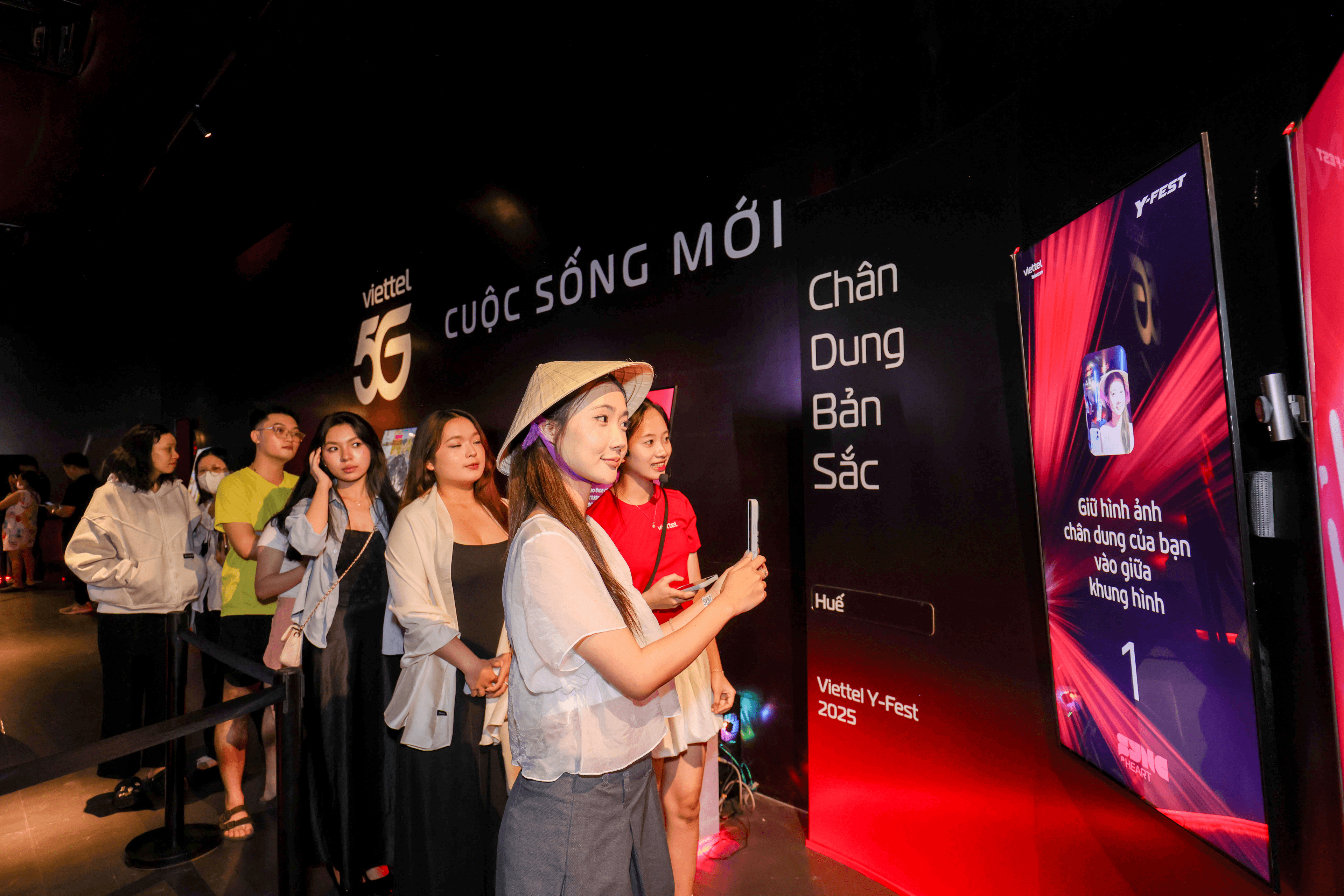 A group of visitors queuing to experience their personalized portrait in the installation
