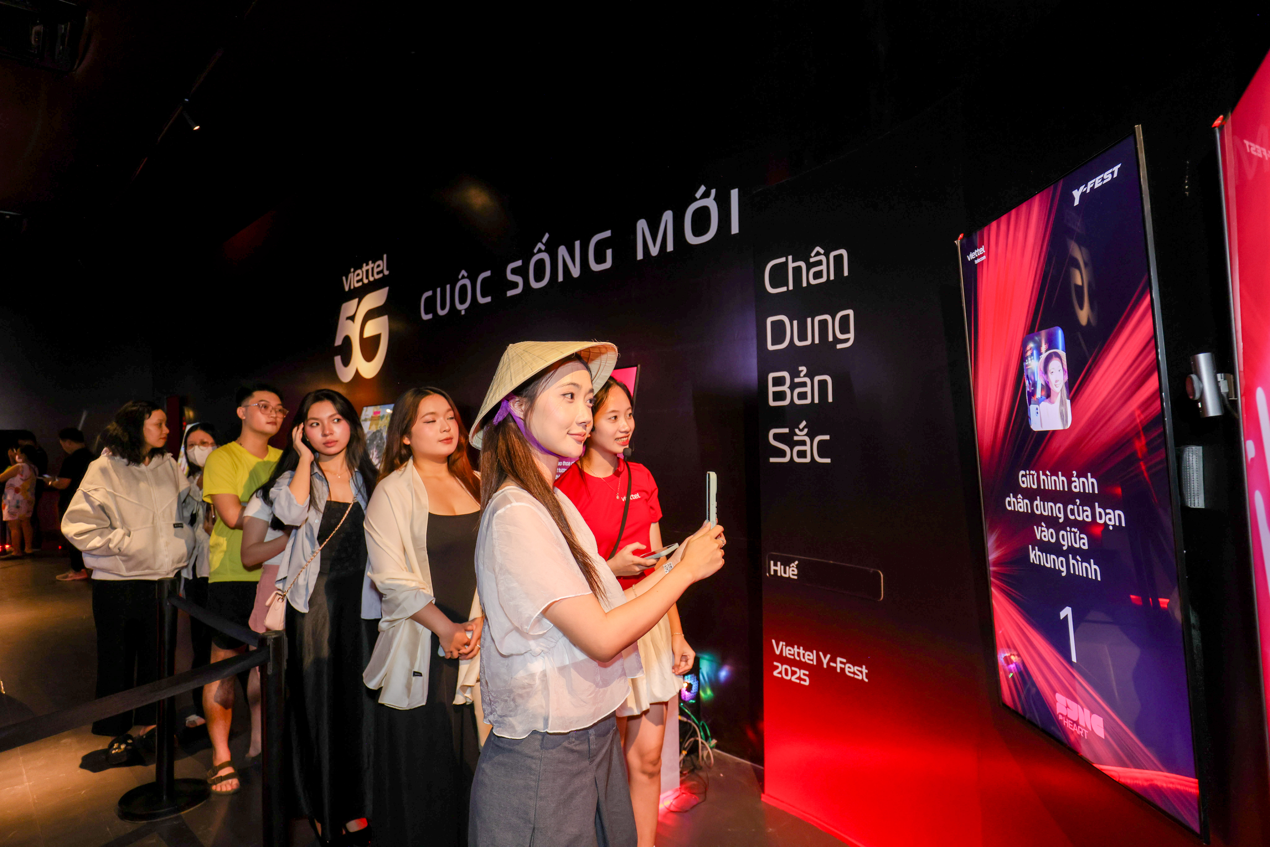 A group of visitors queuing to experience their personalized portrait in the installation