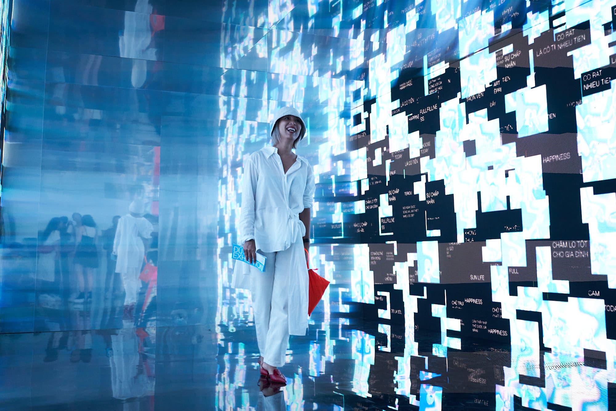 A woman walks through the final installation, viewing an immersive visualization of visitor 'fulfillment' data.